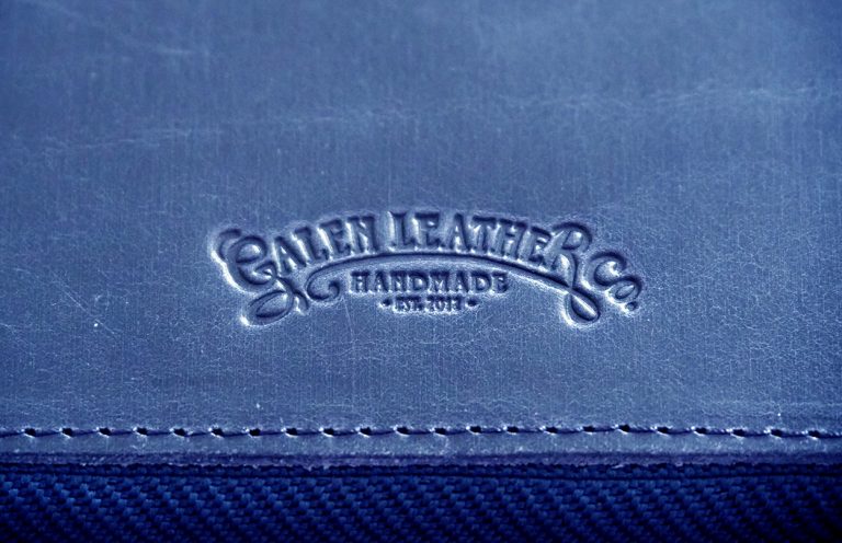 Galen Leather Co logo debossed in navy blue leather.