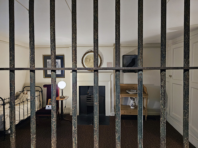 Looking through the prison grille at the Charles Dickens Museum.