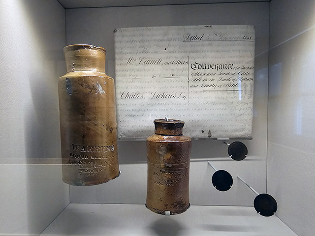 Bottles and tokens from Warren's Blacking Factory.